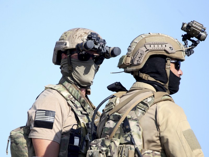 Trump's Policy Failures: A U.S. Navy SEAL special forces operator stands with a colleague.