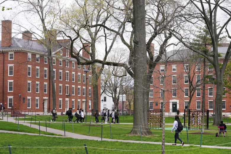 The College Board, the non-profit organization that administers the SAT exam, caved to pressure from the Trump administration, scrapping its race-neutral Landscape tool. The decision undermines fairness and abandons high-achieving low-income students. Here, students walk through Harvard Yard, April 27, 2022, on the Harvard campus in Cambridge, Mass.