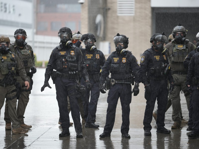 Federal agents retreat into the facility as cyclists with the emergency World Naked Bike Ride protest against ICE and the looming deployment of National Guard troops in Portland, Oregon, on October 12, 2025.