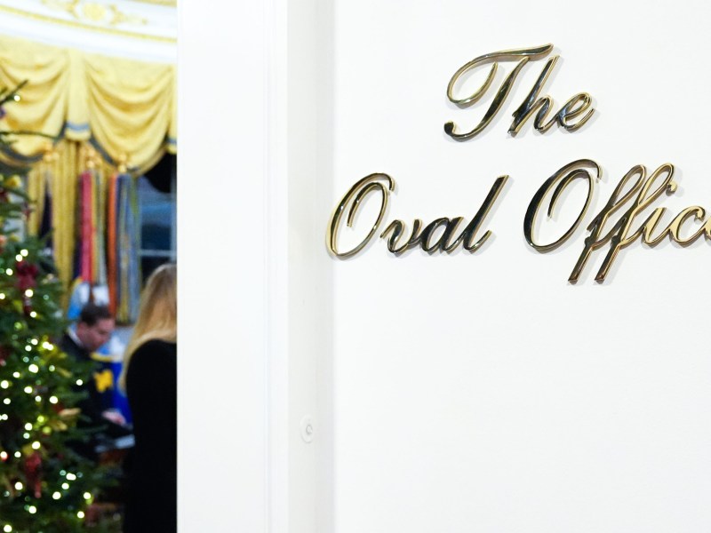 The White-Collar Crime House: A new gold script sign is mounted outside the Oval Office of the White House, Saturday, Dec. 6, 2025, in Washington.
